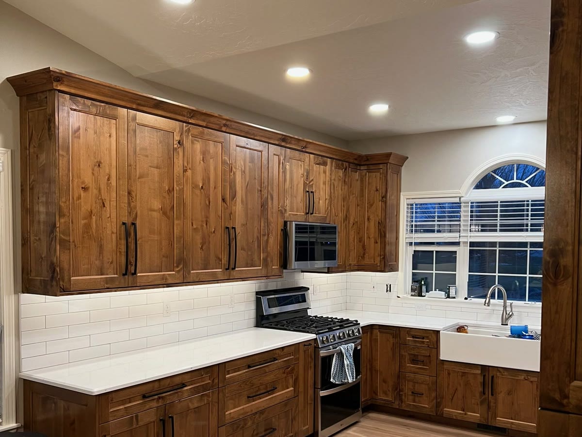 Finished Boise kitchen remodel with custom stained-wood cabinets, deep drawers, and floor-to-ceiling storage