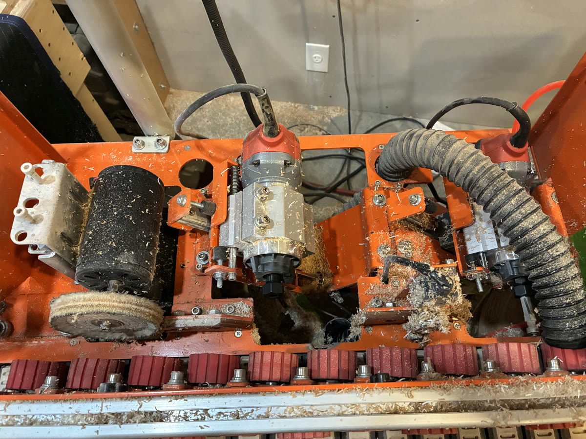 Interior of the shop edgebander showing edge-processing components and dust extraction
